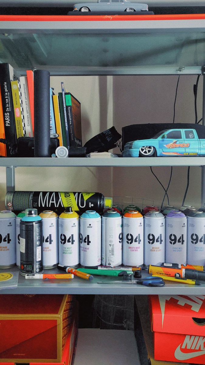 orange and gray toy car on white wooden shelf