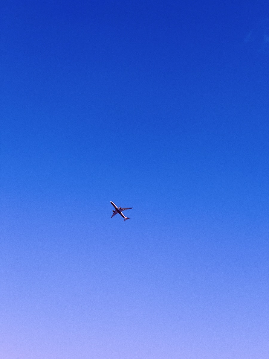 an airplane is flying in the blue sky